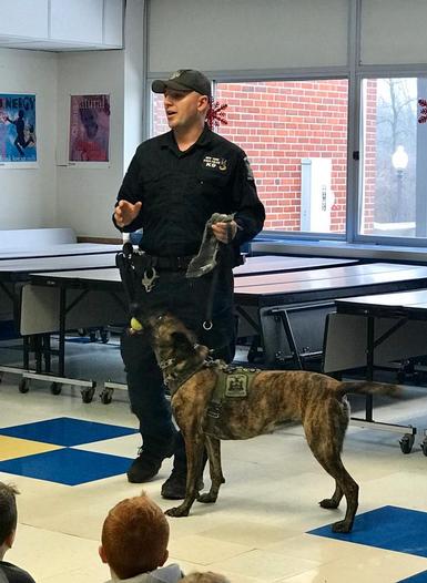 Trooper McDonnell talks to student about the K-9 Unit and his partner, Mic.