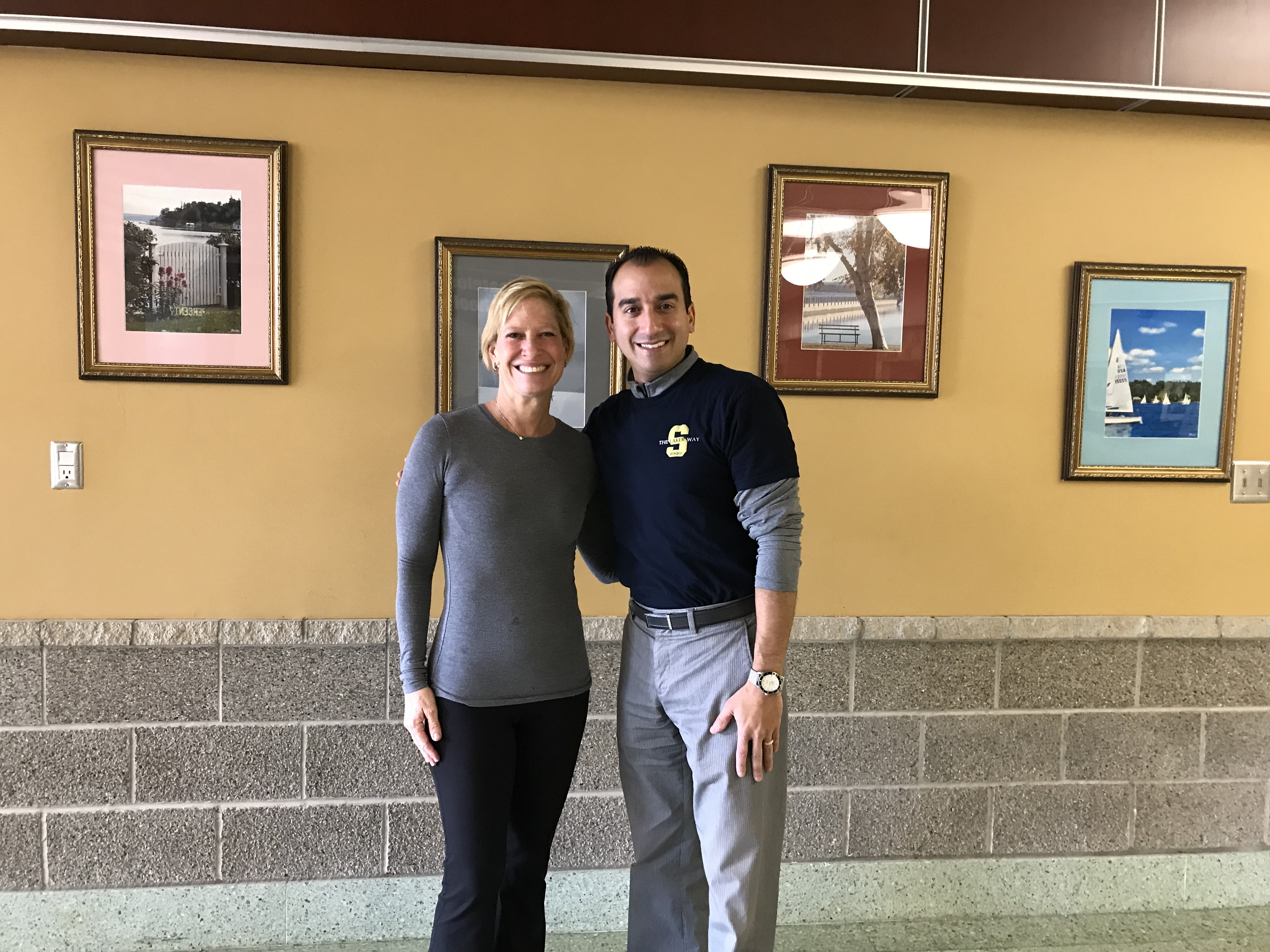 Stacia Landsberg pictured with Greg Santoro in front of her photgraphs of the community.