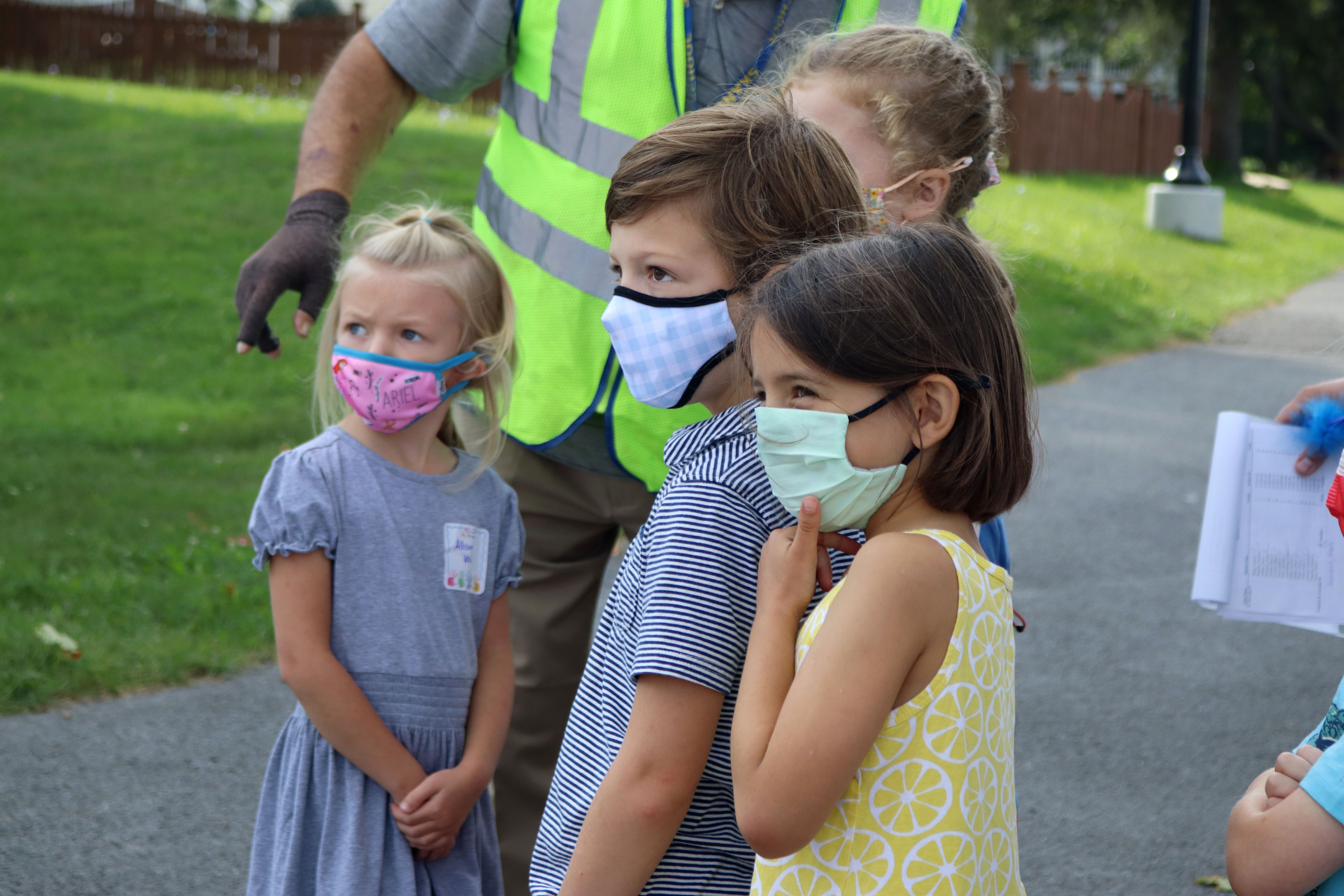 Kindergarten students look on during a bus drill.