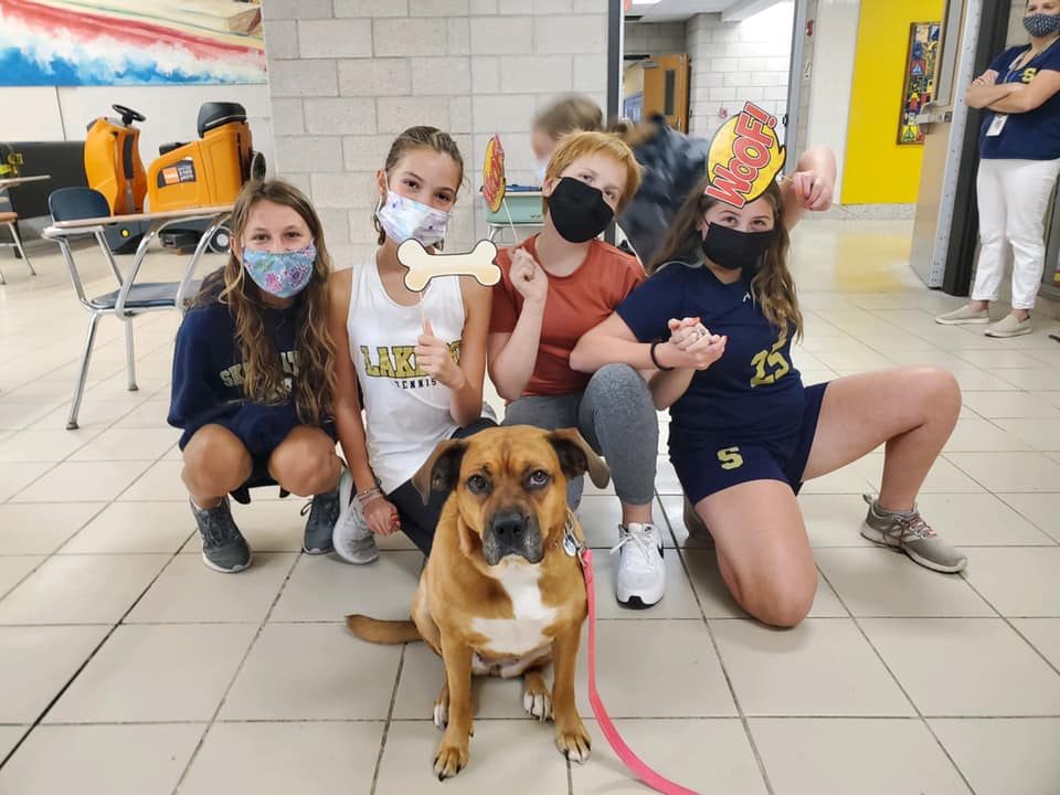 Students pose for a photo with Coco at lunch.