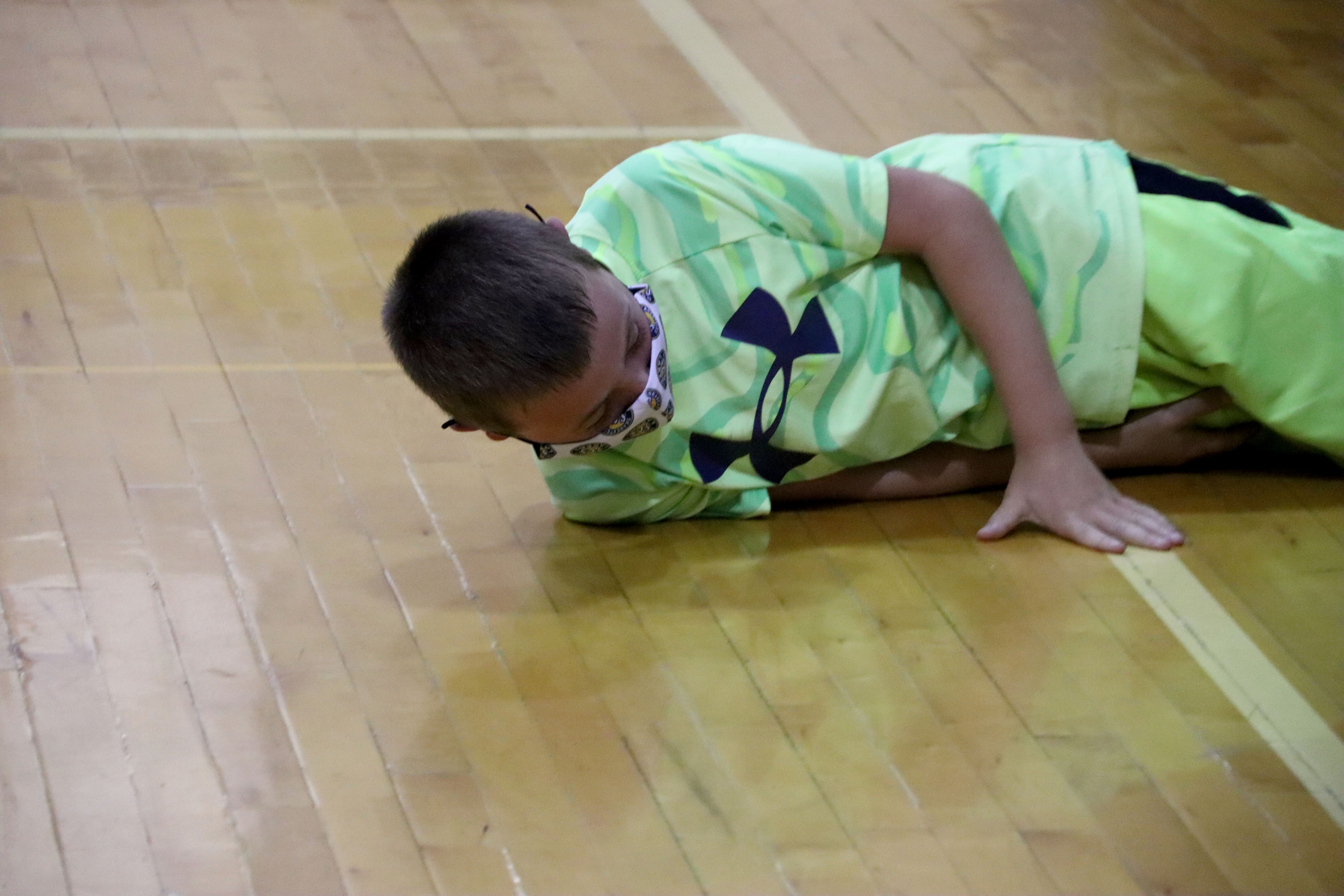 A State Street student demonstrates how to stop, drop, and roll