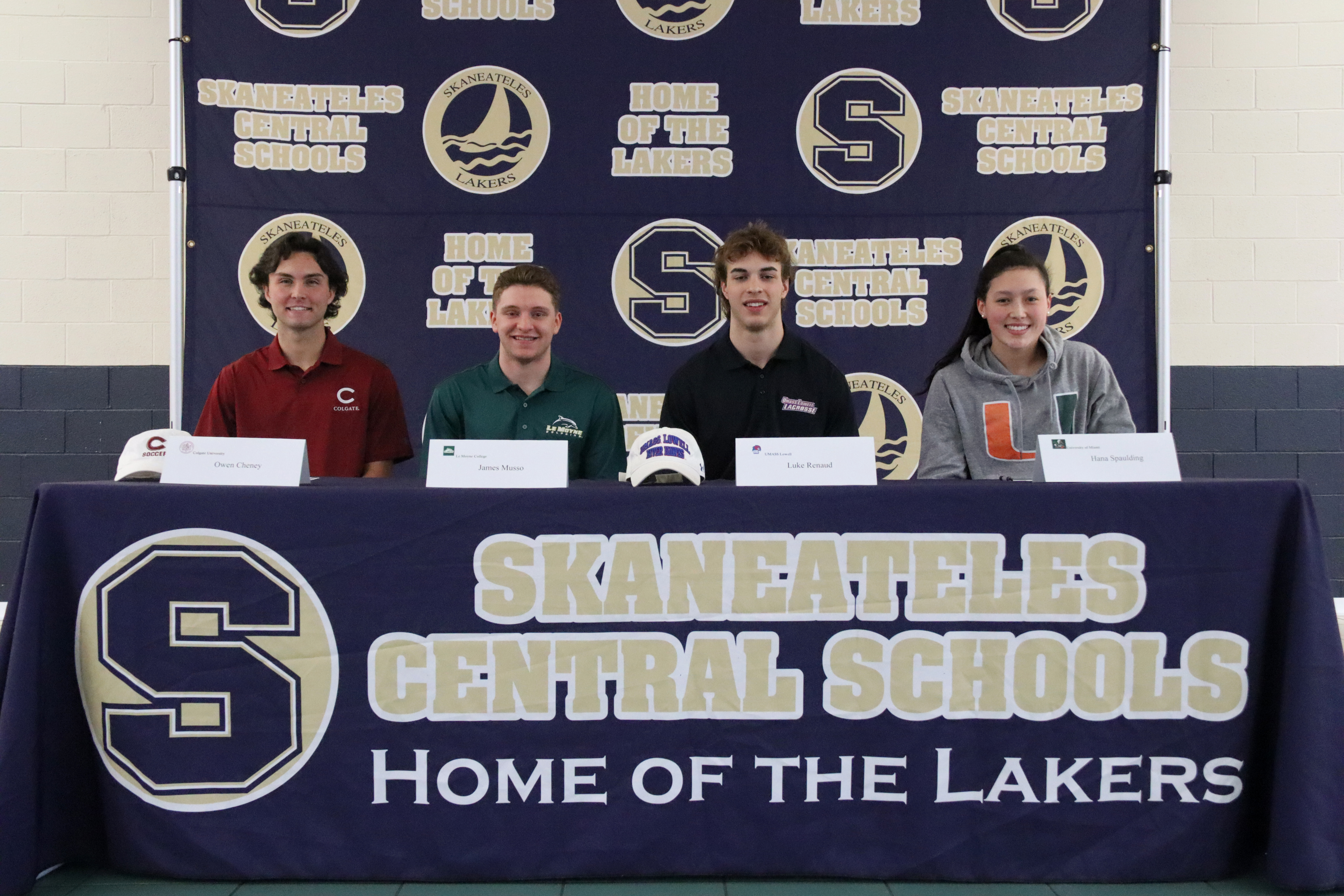Four seniors participate in a National Letter of Intent signing ceremony at the High School Cafeteria