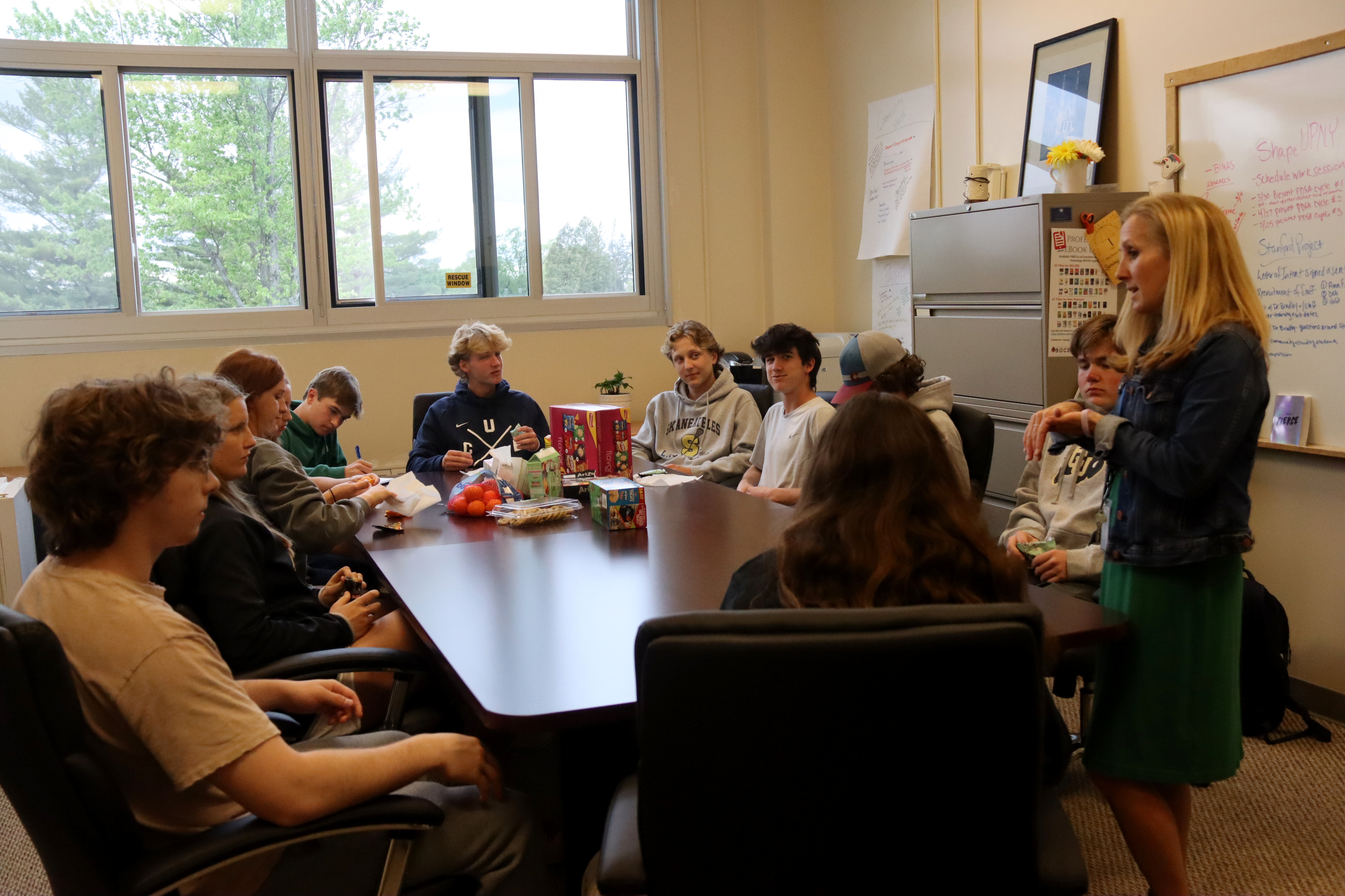 A group of students sit around a table and discuss initiatives for mental health awareness