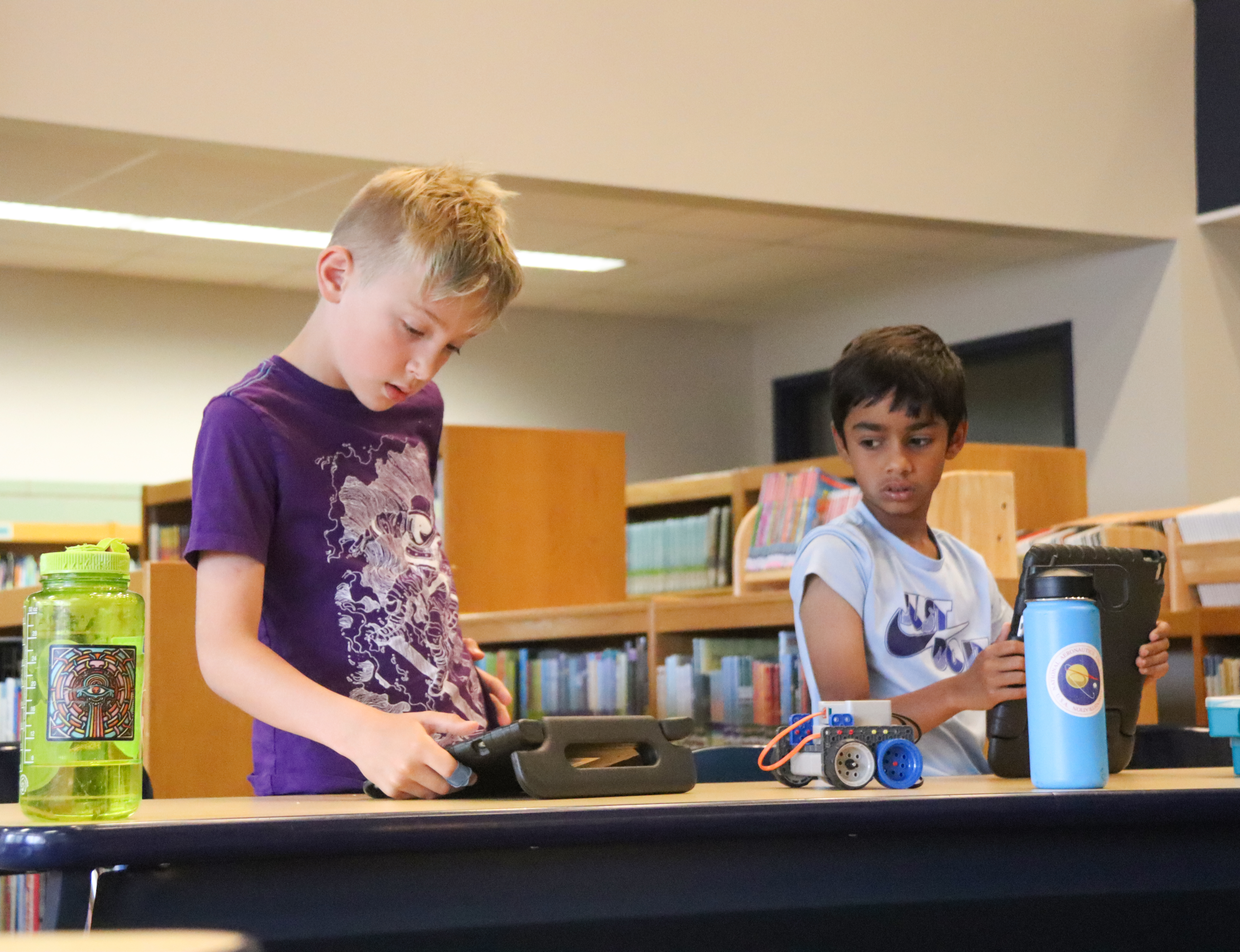 Students configure Vex Go robots at Coding Camp.