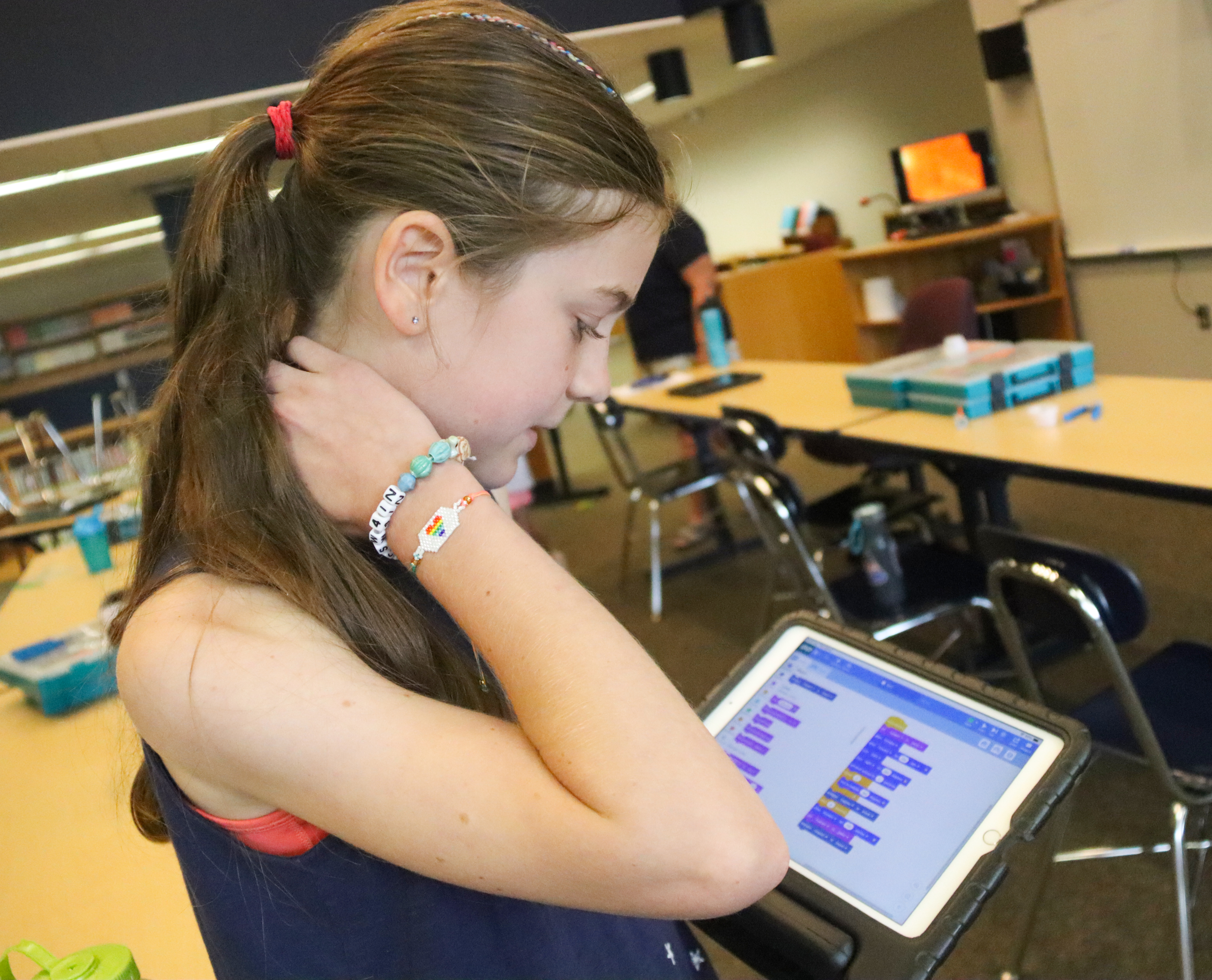 A student works on her robot's path in the Vex Go application.