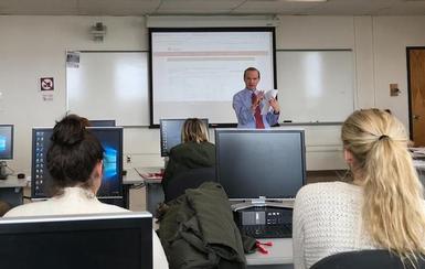 Medical professional instructing students in a group session.