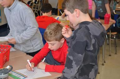 Fourth graders worked on various math problems as part of I Love Math Day
