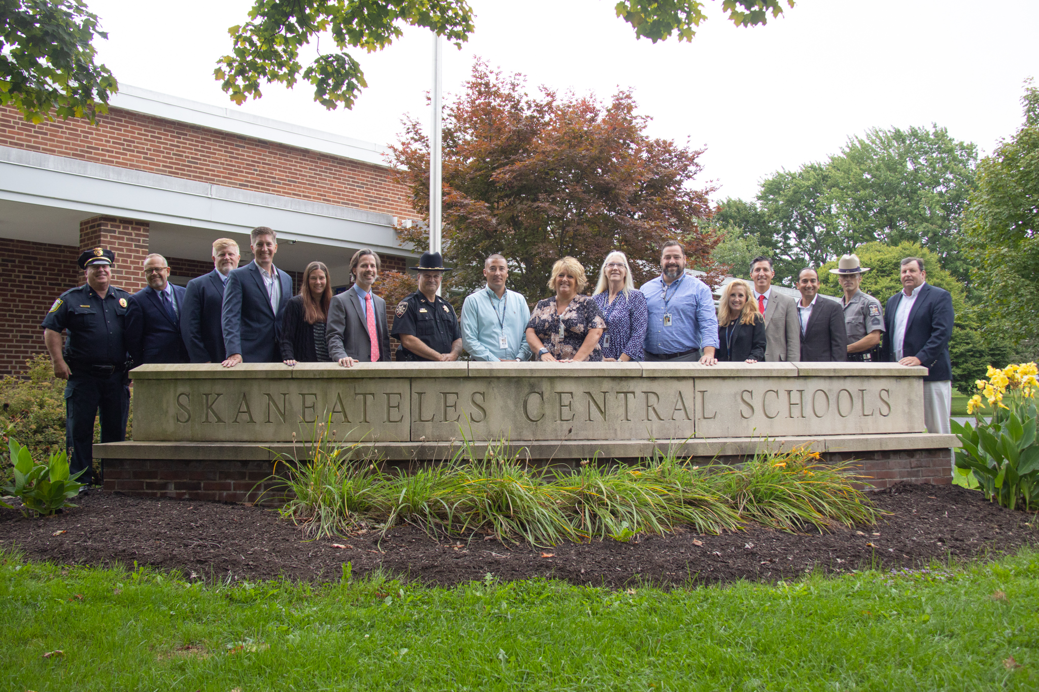Skaneateles administration and police pose in front of the District Office