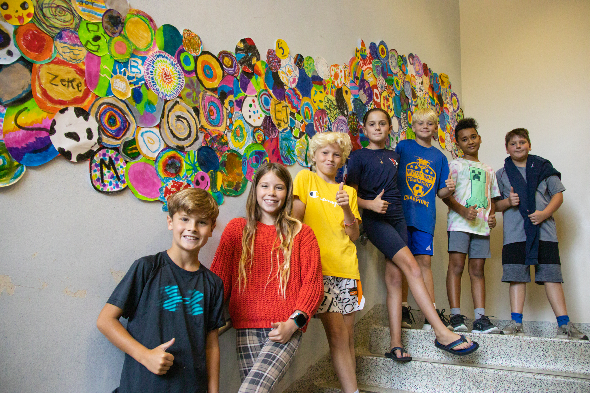 Students lined up next to artwork in State Street hallway