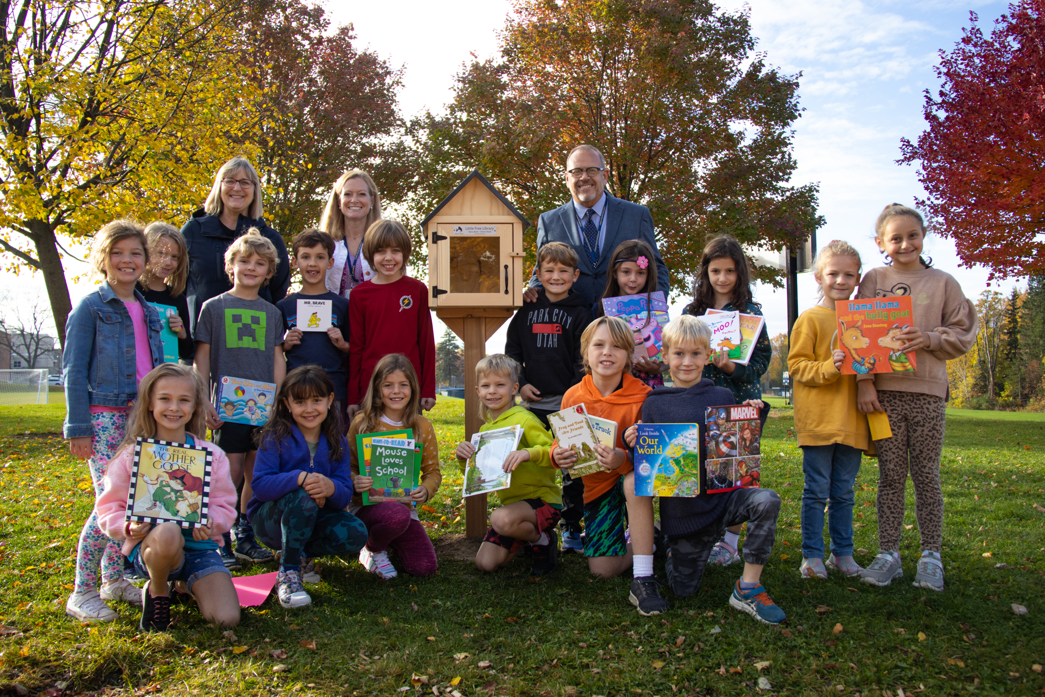 Waterman students display their books and stand around the hut near the playground